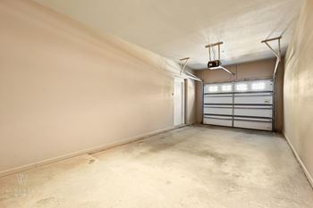 a large garage with white walls and a white garage door